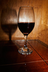 Delicious glass of wine on a wooden board