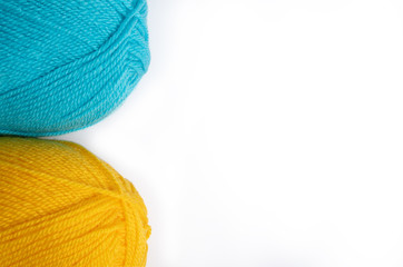 two skeins of wool thread isolate on white, blue and yellow, copy space on right side