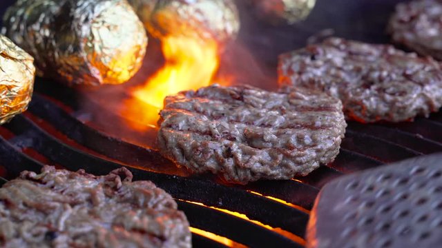 Flipping Hamburgers Patty on BBQ