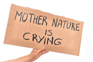 Cardboard banner with MOTHER NATURE IS CRYING text, protesting against climate change over isolated white background