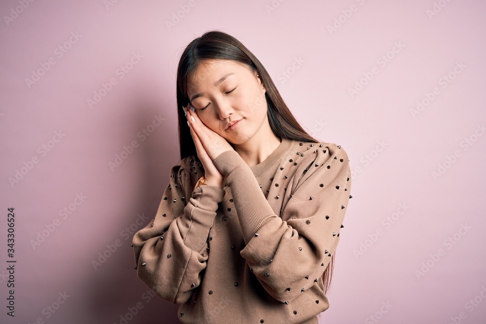 Sticker young beautiful asian woman wearing fashion and elegant sweater over pink solated background sleepin