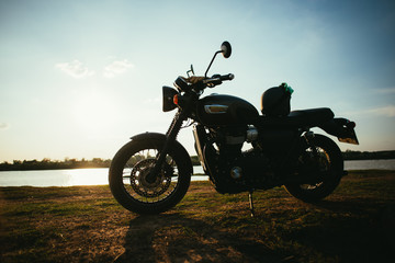 A motorcycle on the road with sunset light background