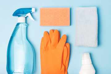Cleaning products, gloves and rags on blue background, spring cleaning concert