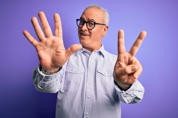 Middle age handsome hoary man wearing striped shirt and glasses over purple background showing and pointing up with fingers number seven while smiling confident and happy.