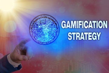 Writing note showing Gamification Strategy. Business concept for use Rewards for Motivation Integrate Game Mechanics Elements of this image furnished by NASA