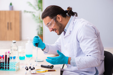 Young male chemist working in the lab