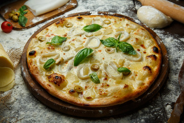 Italian squid pizza with olives and cheese