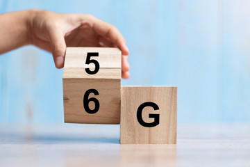 Businessman hand change wooden block from 5G to 6G (Generation of Cellular Mobile Communications) Technology, network, Social media and digital concepts