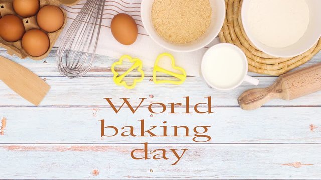 World baking day - Cooking and baking groceries on the table with title - Stop motion 