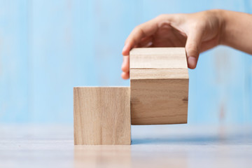 Businessman hand flipping wooden block on table background. Business planning, Risk Management, Solution, strategy, different and Unique Concepts
