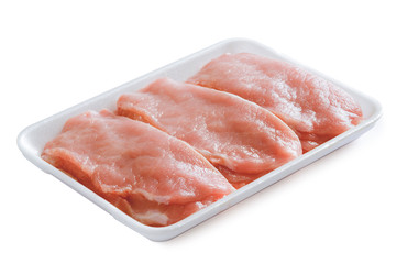 pieces of raw and uncooked chicken fillet in a plastic container