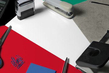 Kuwait flag with office clerk workplace background. National stationary concept with office tools.