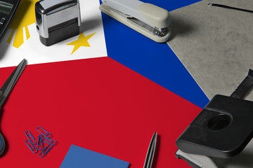 Philippines flag with office clerk workplace background. National stationary concept with office...