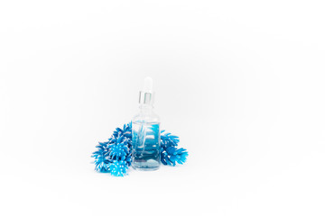 Hyaluronic acid Dropper transparant glass Bottle. Skincare and health concept. Glass bottle  on white background with classic blue succulent.