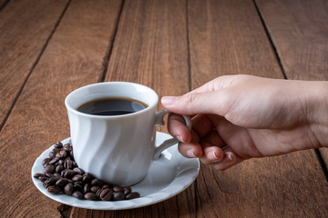 
Black coffee in a white coffee mug on a wooden table