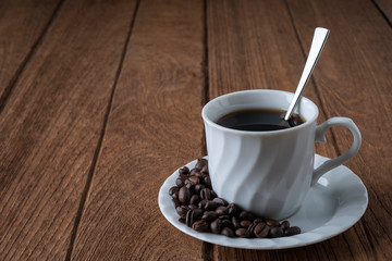 
Black coffee in a white coffee mug on a wooden table