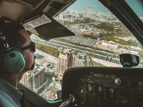 Man Flying Helicopter Over City