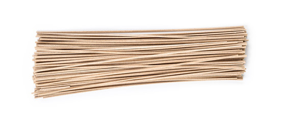 Dried buckwheat soba noodles on white