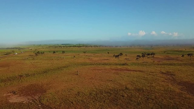 Drone footage of misty Australian outback landscape. 