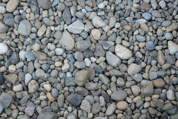 Closeup multicolored pebble stones background.