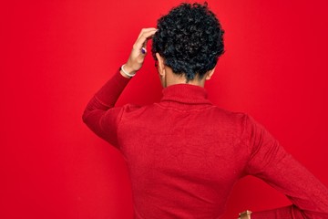 Fototapeta na wymiar Young beautiful african american afro woman wearing turtleneck sweater and glasses Backwards thinking about doubt with hand on head