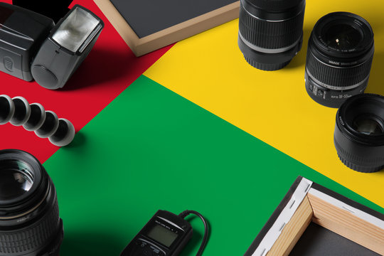 Guinea national flag with top view of personal photographer equipment and tools on white wooden table, copy space. - Powered by Adobe