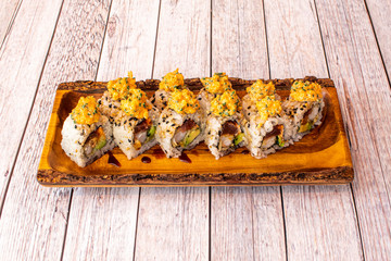 Ration of uramaki on wooden table