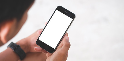 Cropped shot view of man hands holding smart phone with blank copy space screen for your text message or information content, female reading text message on cell telephone during in urban setting. 