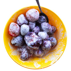 Close-up of fresh strawberries covered with cream and sugar. Isolated on a white background