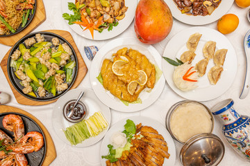overhead shot of chinese food on white table