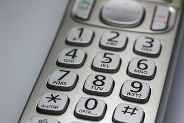 Close up abstract view of the keypad on a handheld cordless landline home telephone