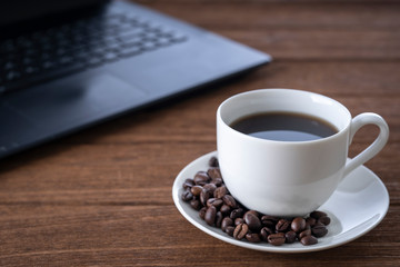 Fototapeta na wymiar Black coffee in a white mug on the desk