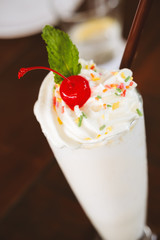 Dairy free healthy shake on the wooden table. Online menu item. Healthy treat, online order, delivery, summer sweet concept. Soft focus