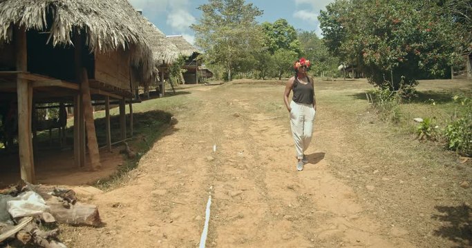 An east indian woman walks out of camera frame in the tribal community of the Embera tribe, Panama
