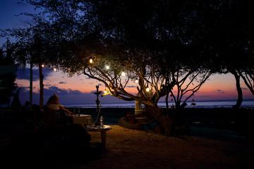 Fototapeta na wymiar Wonderful sunset seen from one of the many bars and restaurants that can be found in the western beaches of Gili Trawangan island, one of the most impressive spots in Lombok, Indonesia.
