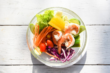 Salad vegetable breakfast in the morning - salad shrimp with fruit and fresh lettuce tomato carrot bell pepper on bowl on table healthy food eating concept