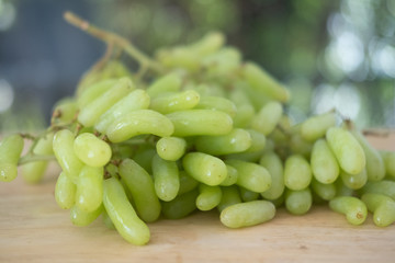 Bunch of fresh green grapes on wood table. Healthy fruits