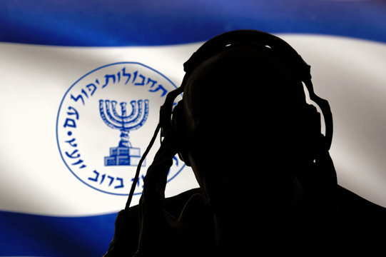 Secret agent of the Israeli intelligence eavesdropping on conversations, spy and special agent, the Israeli flag of the special services. Hebrew inscription, image of the menorah.