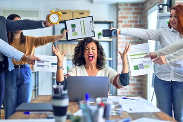 Group of business workers working together. Partners stressing one of them at the office