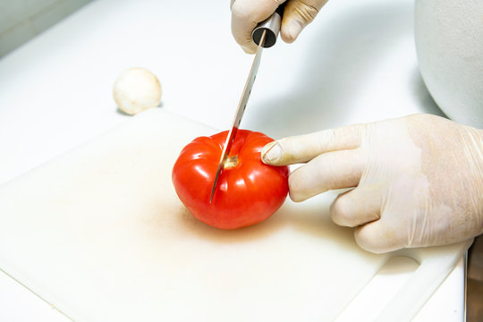 Cutting Tomatoes With White Gloves