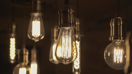 Vintage style light bulbs hanging from the ceiling. Old Edison bulb.