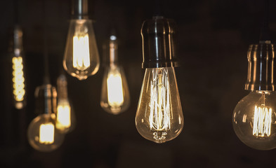 Vintage style light bulbs hanging from the ceiling. Old Edison bulb.