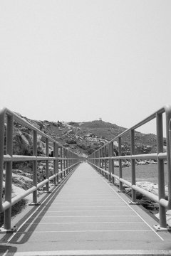 Boardway Leading Towards Hill Against Clear Sky