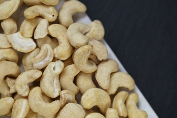Cashew nuts on a black background.Cashew nut background.Useful fats.Organic  bio product.healthy snack and dessert.	