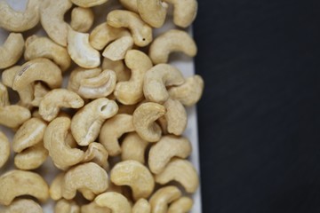 Cashew nuts on a black background.Cashew nut background.Useful fats.Organic vegan  product.healthy snack and dessert.	