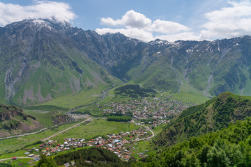 Fototapeta na wymiar Kazbegi village in summer season, small village surrounded by Caucasus mountains range in Georgia