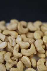 Cashew nuts on a black background.Useful fats.Organic vegan bio product.healthy snack and dessert.	