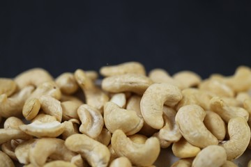 Cashew nuts on a black background.Cashew nut background.Useful fats.Organic vegan bio product.healthy snack and dessert.	