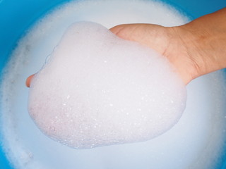 Above of bubble in hand on washing basin, washing dirty clothes with hand