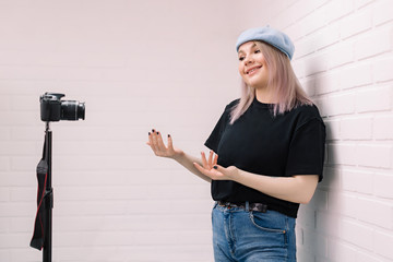 Blogger in front of the camera. White background.